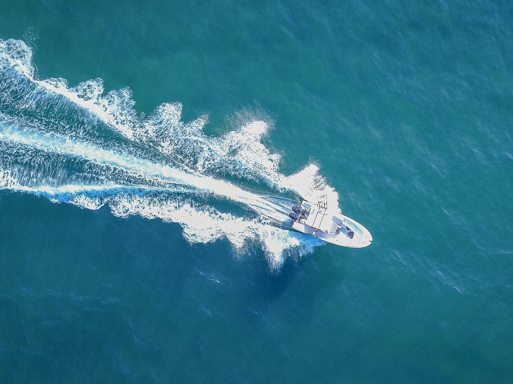 A center console boat running across open water